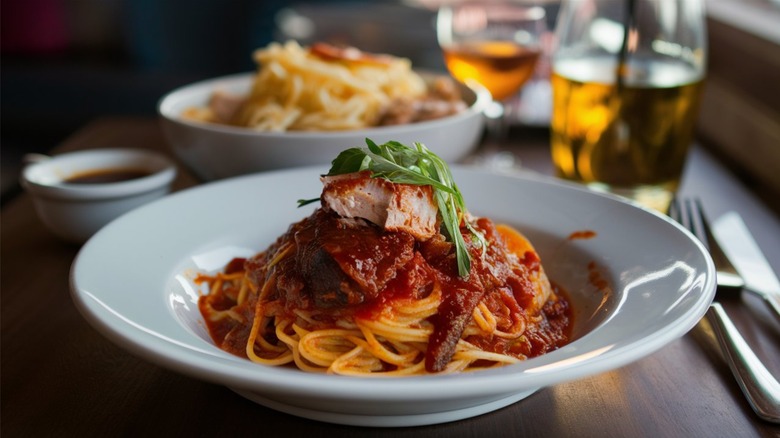 Barbecued meats and sauce atop spaghetti