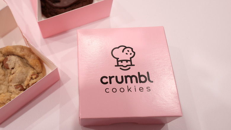 Crumbl cookie boxes on table