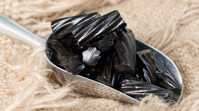 black licorice in metal scooper