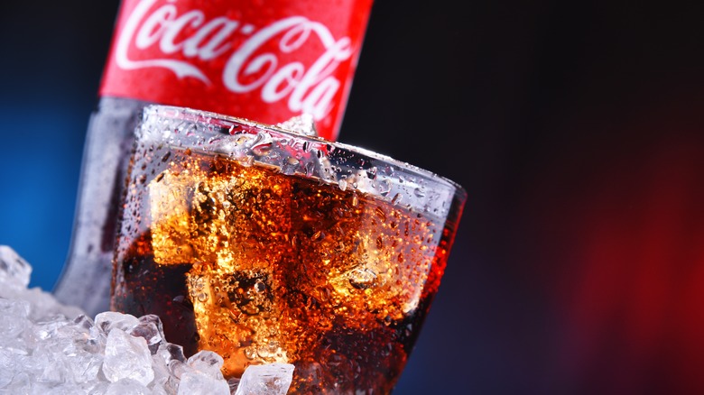 A glass and bottle of Coca-Cola