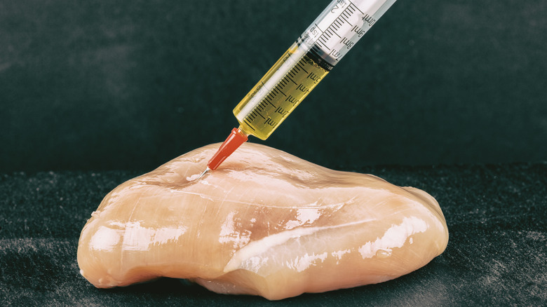 Chicken injected with syringe