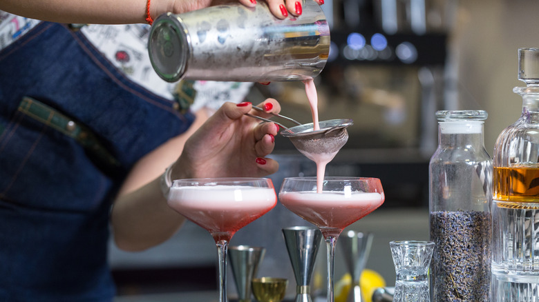 woman straining drinks