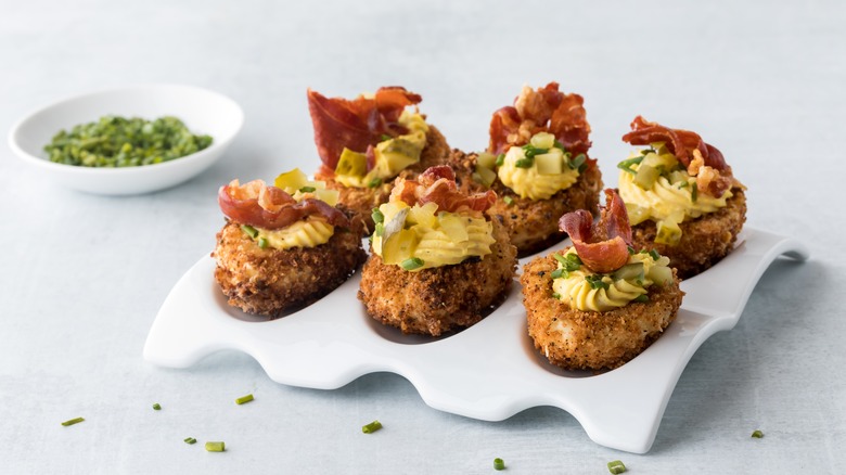 Fried deviled eggs topped with prosciutto