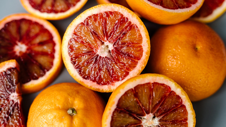 An assortment of blood oranges, sliced and whole