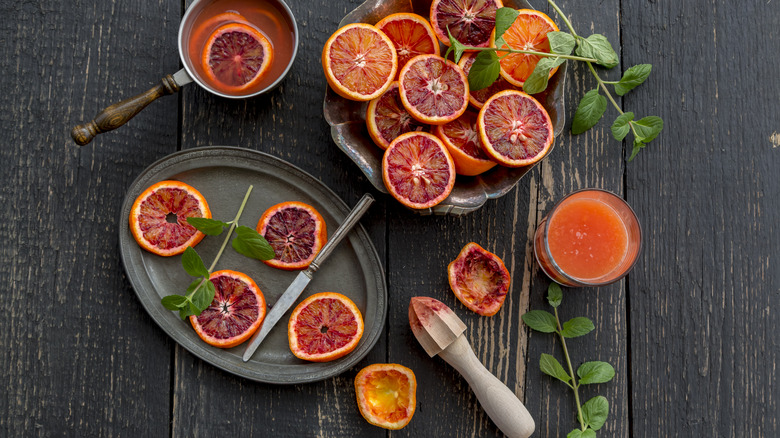 Sliced blood oranges plated and juice in cups