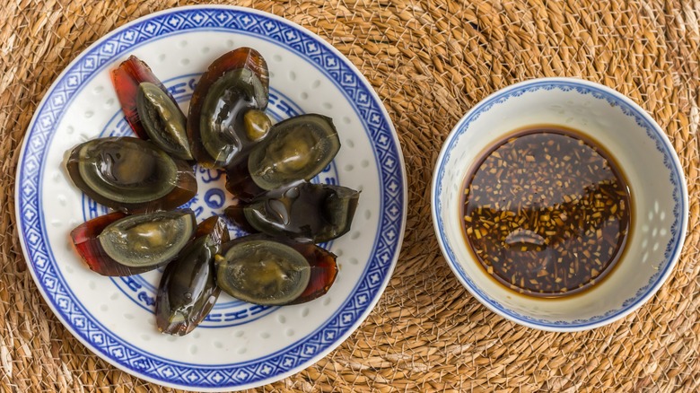 sliced century eggs with sauce