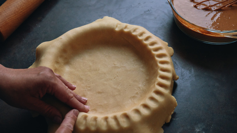 taking a pie from oven