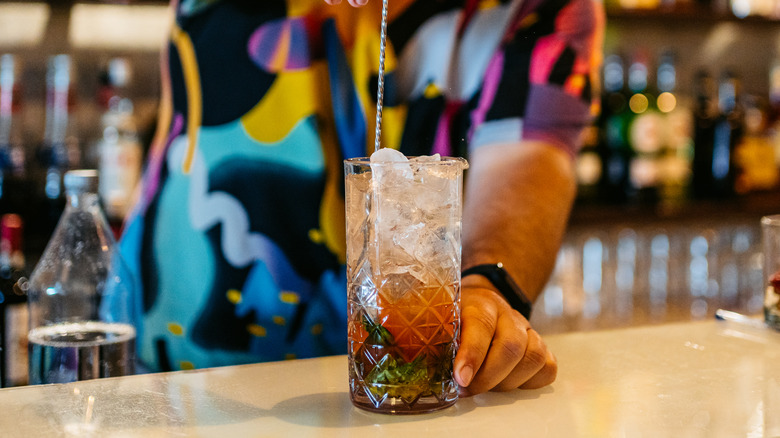 bartender stirring cocktail