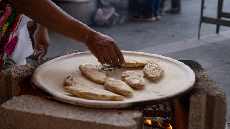 Cooking bread on a clay comal