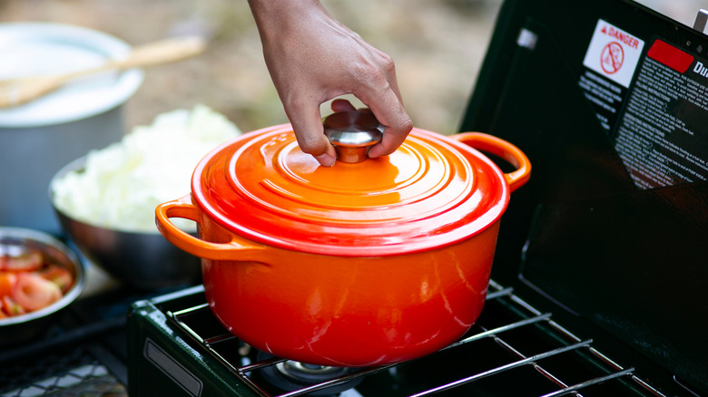 hand on dutch oven handle