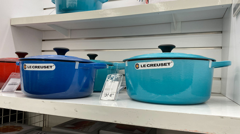 le creuset dutch ovens on shelf