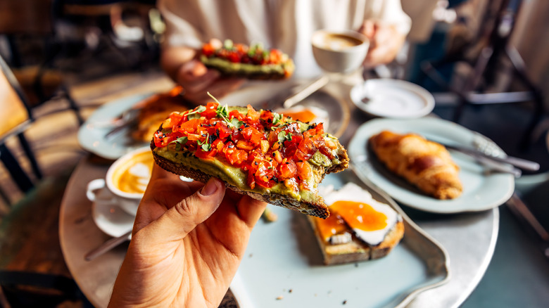 Foodie holding bruschetta toast