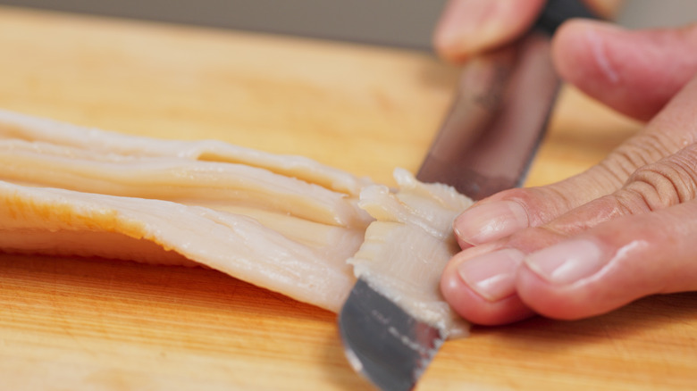 Cutting fresh geoduck