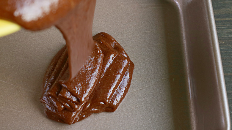 pouring chocolate batter in pan