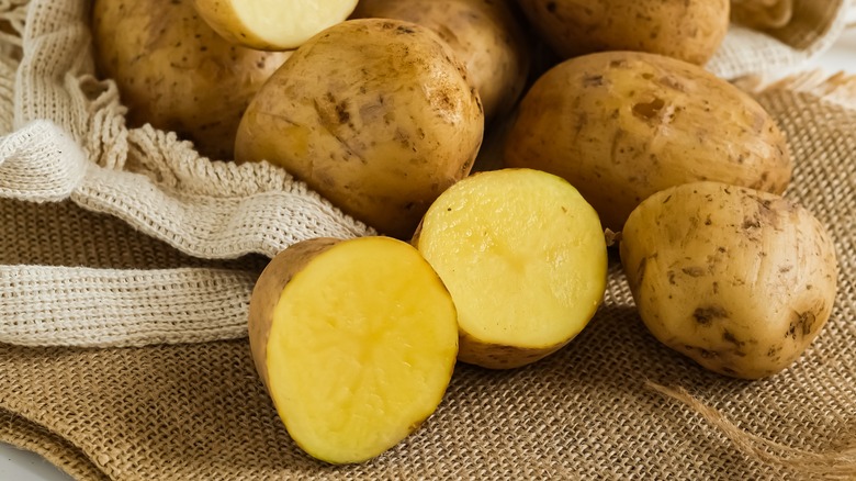 bag of whole, regular potatoes with some halved