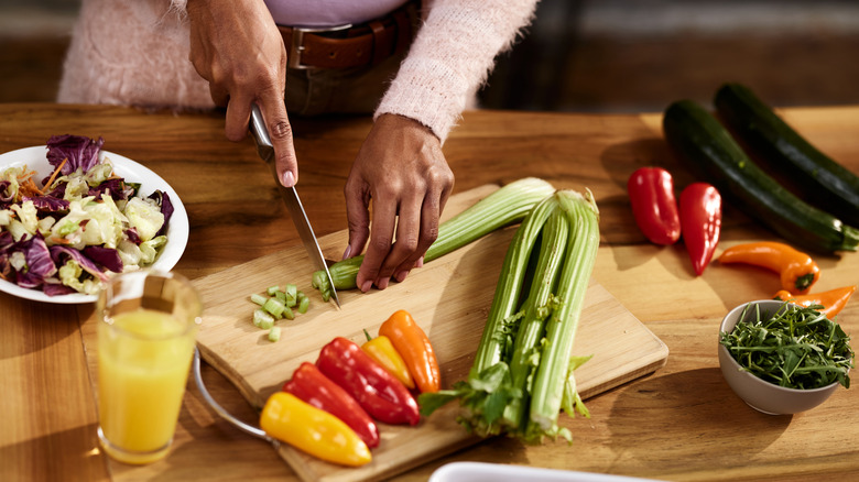 woman chopping vegetables for salad