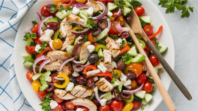 bright mixed salad in bowl with ingredients cut into small pieces