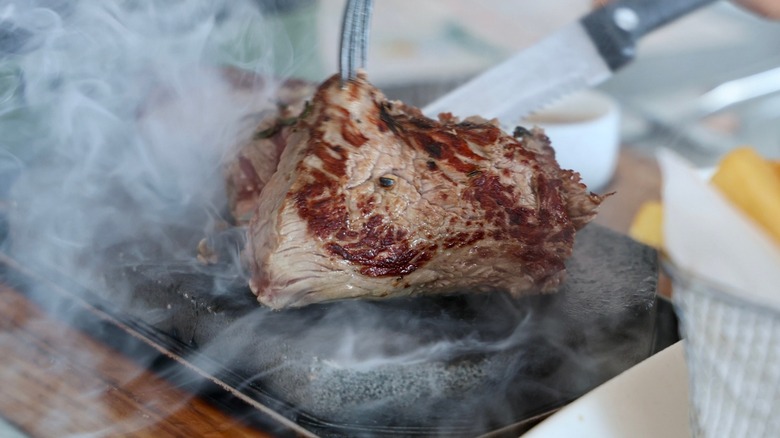 Close-up of steak cooking on a steak stone