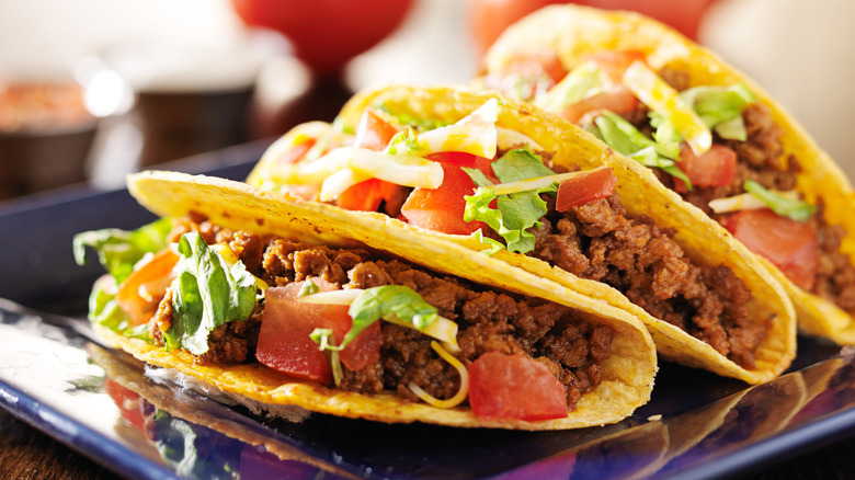 plate of three hard shell beef tacos