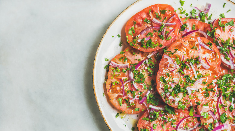 Tomatoes with red onion herbs