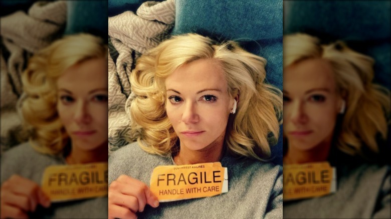 Sarma Melngailis holding Fragile sticker