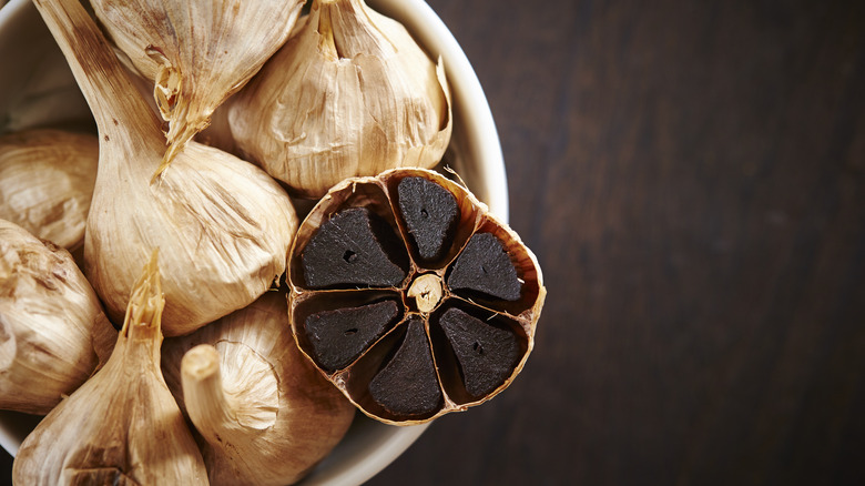 bowl of black garlic bulbs