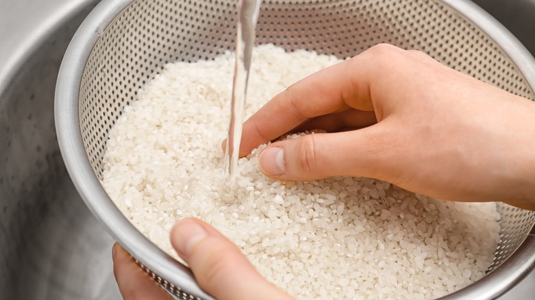 woman rinsing rice