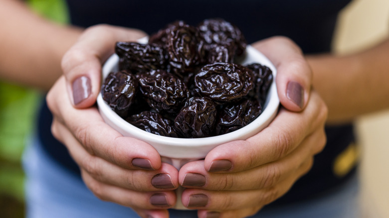 woman holding dried plums