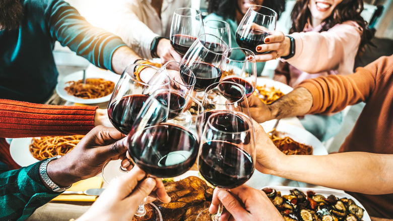 Large group toasting wine glasses