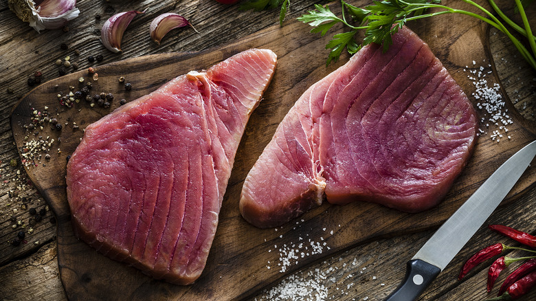 Raw tuna steaks on board