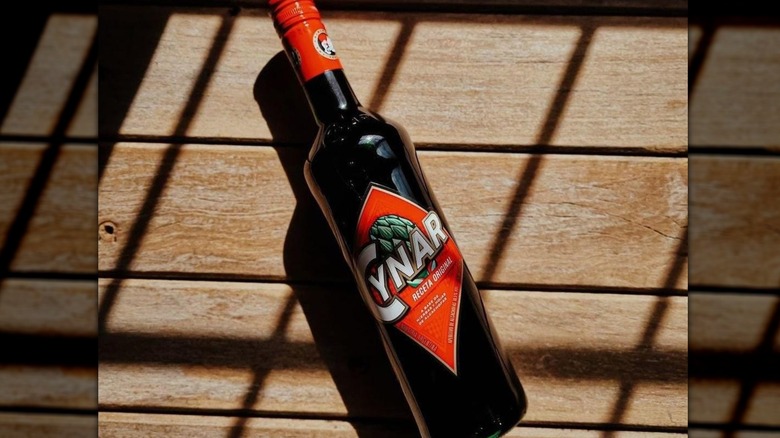 Cynar on wooden table
