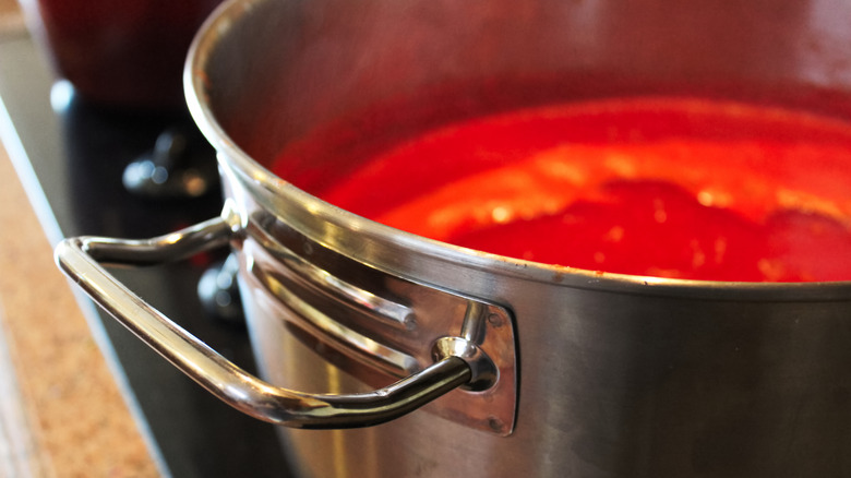 Tomato sauce on stove in metal pot