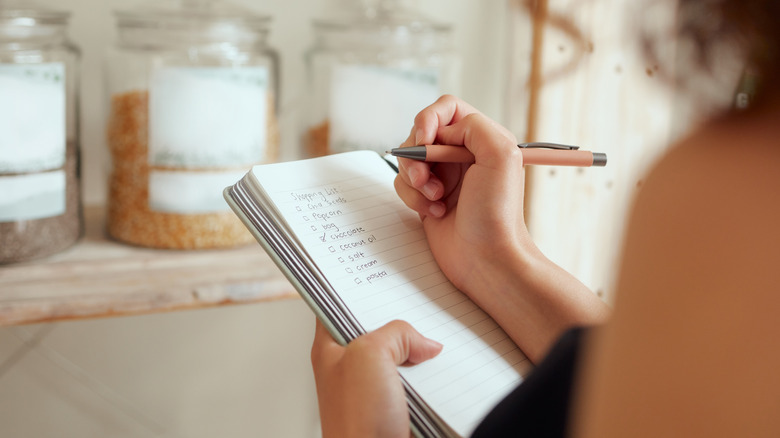 Woman making a shopping list