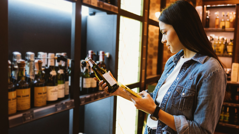 woman holding wine bottle