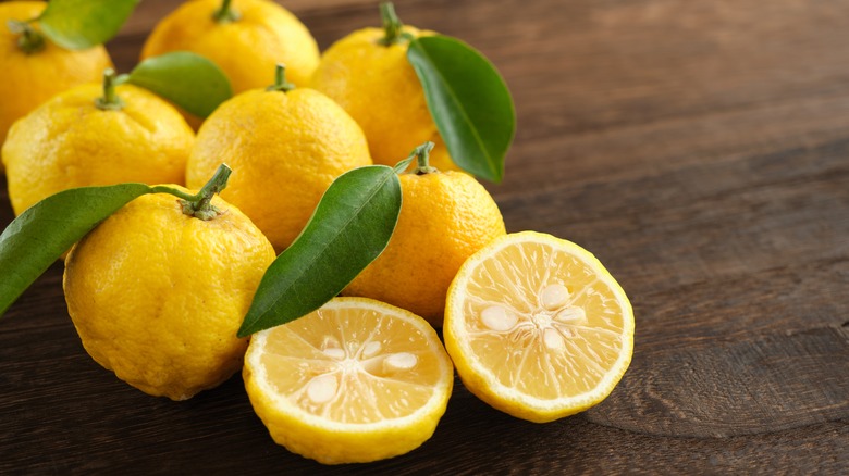 Freshly harvested yuzu fruit on a wooden table