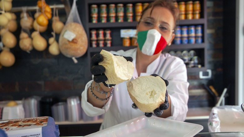 cheesmonger displaying scamorza