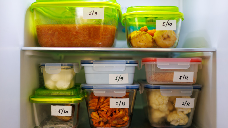 labelled green storage containers filled with food