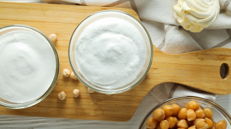 Overview of whipped aquafaba in a bowl with chickpeas