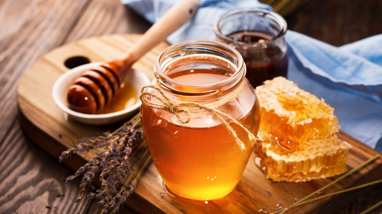 honey in a jar next to honey comb