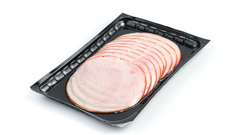 Sliced turkey ham in black packaging