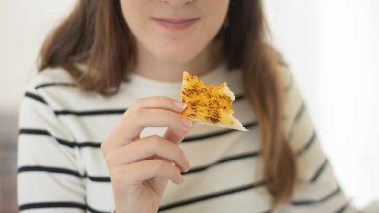 teenager eating a vegemite toast 