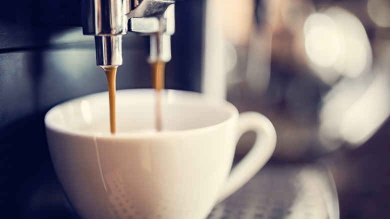 Espresso machine pouring brew into cup