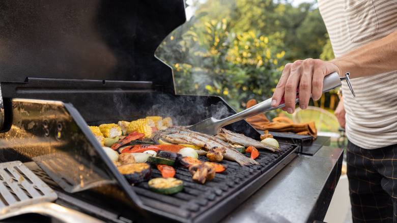 man using outdoor grill 