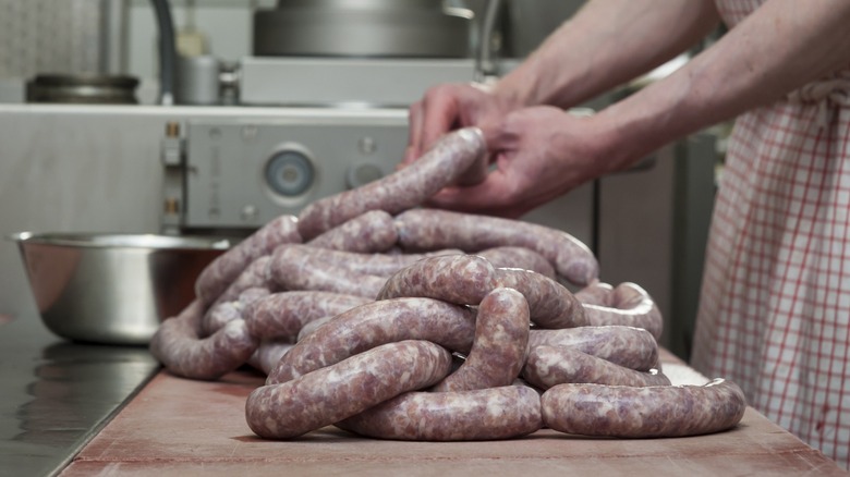 Hands making sausage in a kitchen