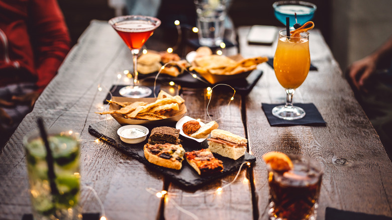 bar food and cocktails laid out on a table