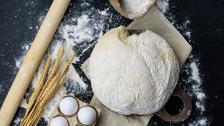 floured bread dough on board