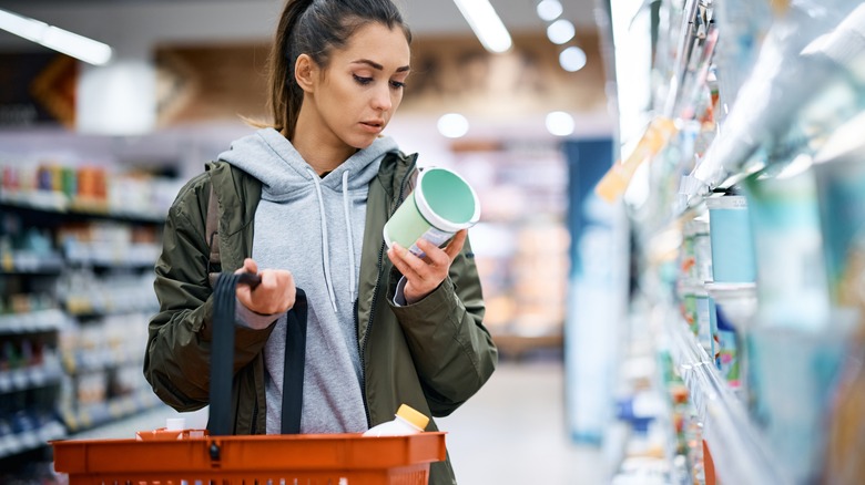 Person buying yogurt at store