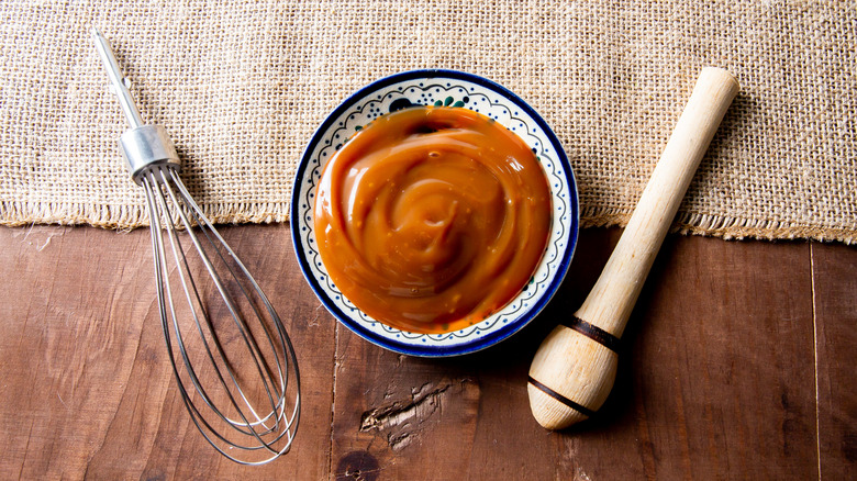 a bowl of cajeta and utensils