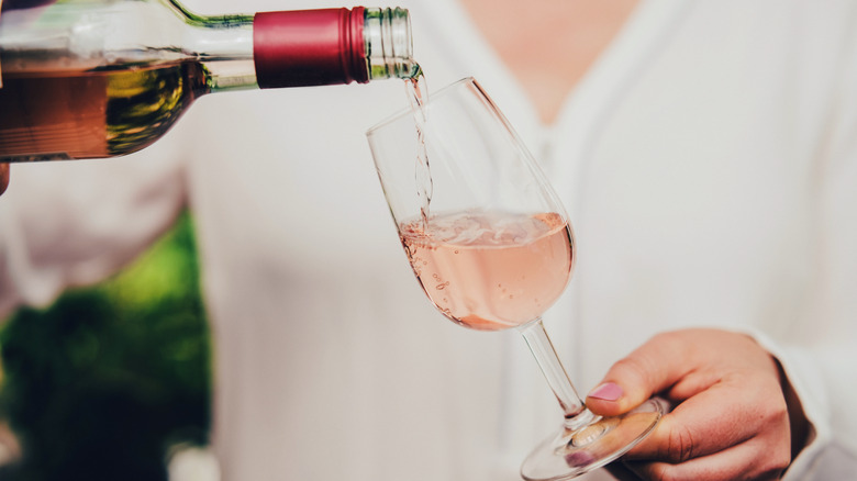 Woman pouring glass of rosé