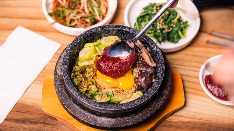 Gochujang added to dolsot bibimbap